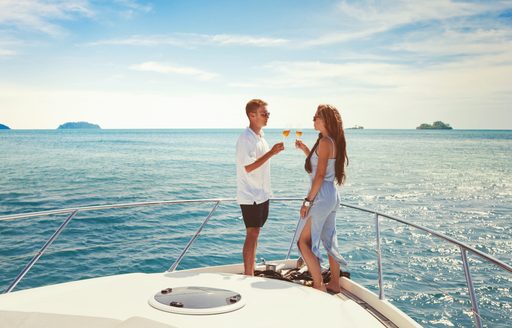 Couple drinking champagne on deck