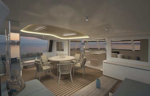 Tables, chairs and sofa on deck of Sunpad on deck of Silent 80 Tri-Deck