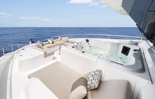 Forward deck of  Horizon FD87 with large sunpads and jacuzzi