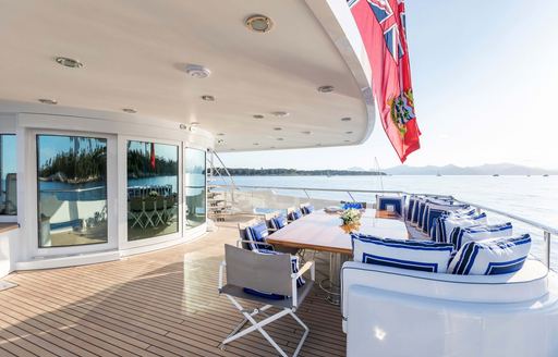 aft deck of superyacht with red ensign