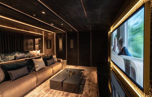 Comfortable seating and cinema screen on superyacht TATIANA