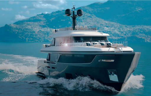 Navetta 30 yacht with a black hull and white superstructure cuts through the water with hills in background