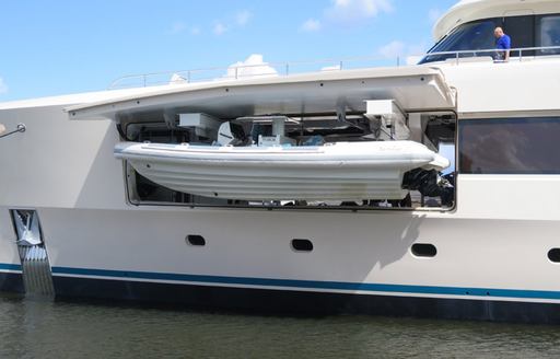 Boat being lowered from tender garage 