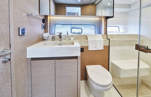 Small but elegant bathroom on yacht, toilet and sink next to each other