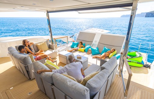 Family lounging in comfortable chairs on deck of Sunseeker 90 Ocean