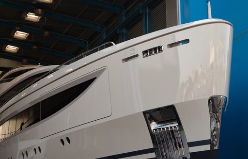 A starboard-side view of Benetti superyacht IRYNA's bow as it emerges from the shed following its completion