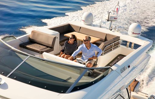 couple driving the Prestige 603 S yacht