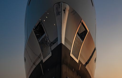 A view from below of Benetti superyacht IRYNA's commanding bow, complete with stainless steel fixtures and anchor pockets