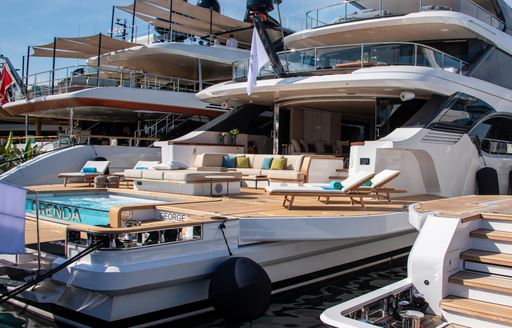 Benetti OASIS 40M yacht ORENDA for sale at Cannes Yachting Festival  yahct is shown from the pontoon on the starboard side aft looking towards the yacht, pool can be seen, yacht next to it on her starboard side, yacht unknown