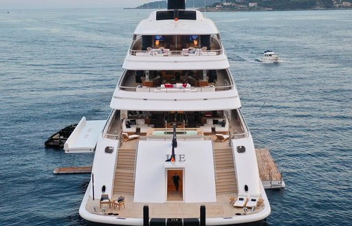 Aft view of megayacht IJE, all aft decks visible, including fold down balconies on both port and starboard sides.