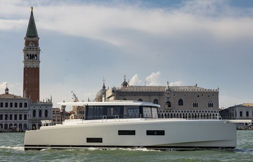 A motor yacht for sale cruising by the Venice Arsenale