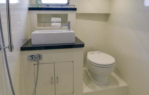 Small toilet on yacht. Toilet next to sink