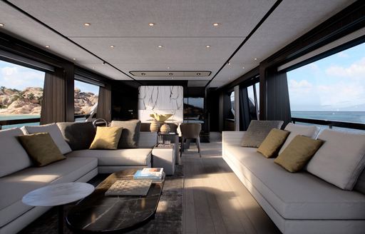 The Ferretti 940 salon boasts large sofas running along either side of the yacht, and large full height windows for expansive views out