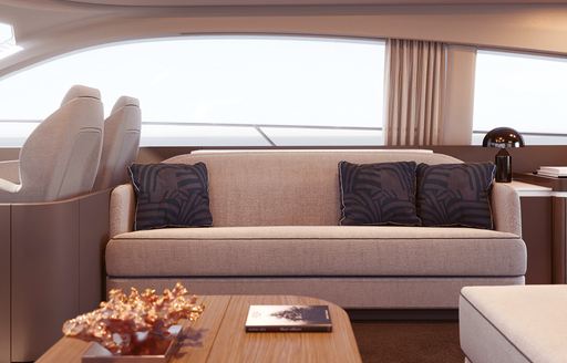 Comfortable sofa with table in front and windo behind on Azimut 53