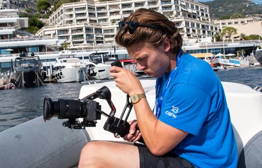 man filming on boat