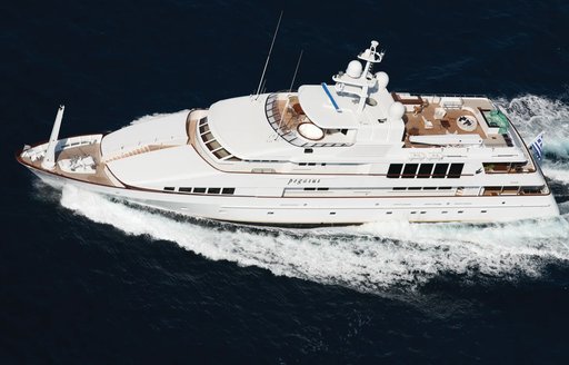 Feadship yacht PEGASUS shown in aerial running shot over port side profile, moving at speed in calm waters