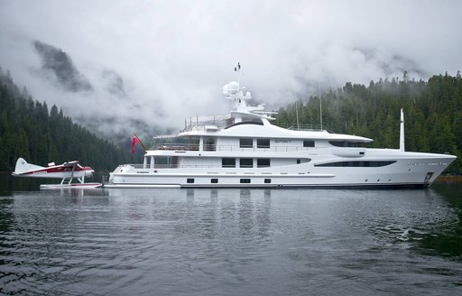 superyacht on anchor with sea plane