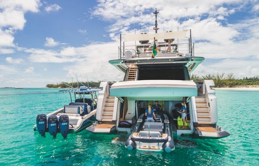 RIB tender being pulled on board yacht to go in tender garage