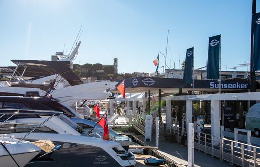 Cannes Yachting Festival 2024 Opening Day sunseeker stand with sunseeker boats moored to pontoon, blue sky