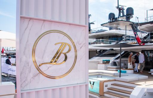 Benetti flag banner at Cannes yacting festival where yacht Orenda is for sale, the yacht in background is yacht VIV