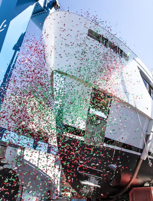 Upwards view of Benetti Oasis 34M hull during launch ceremony. Image of under bow decorated by falling confetti.