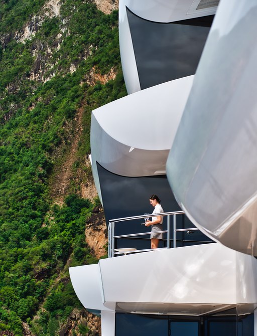 Lady standing in front of expansive glass window on Superyacht ARTEFACT