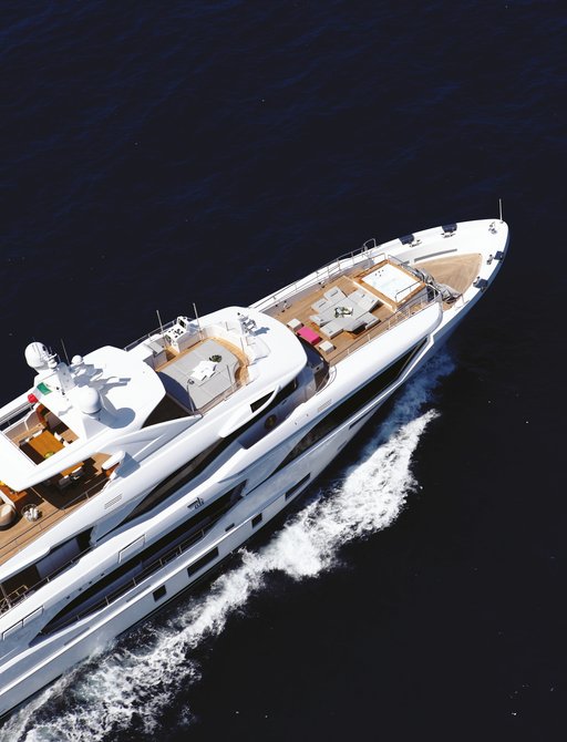 Aerial view looking down on a superyacht bow underway at sea