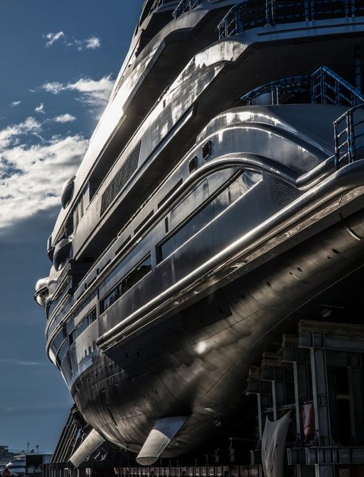 Steel exterior of LANA superyacht by Benetti, sun glinting off of body of the yacht