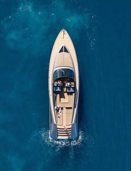 Large chase boat viewed from above on clear blue water