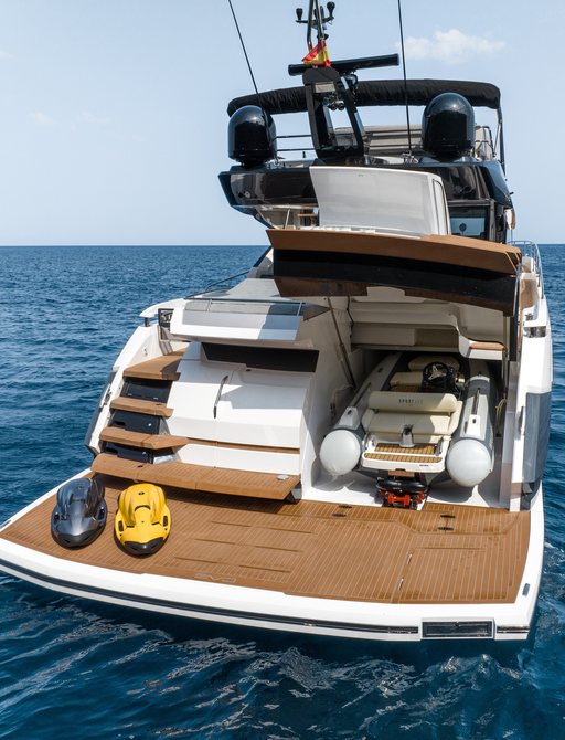 Overview of the Sunseeker 75 Sport Yacht swim platform and aft deck, tender garage open revealing tender in storage.