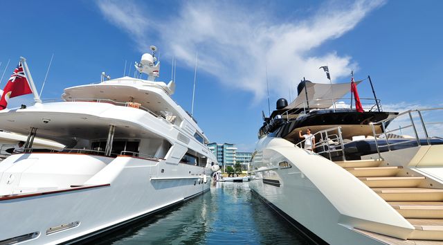 Close up of two superyachts at Singapore Yacht Show