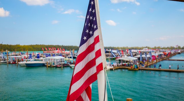 American flag in foreground with boats in background