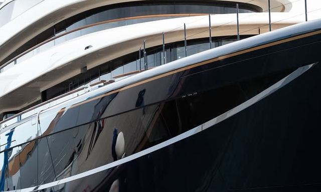 Destiny yacht Deep navy hull with brass detailing