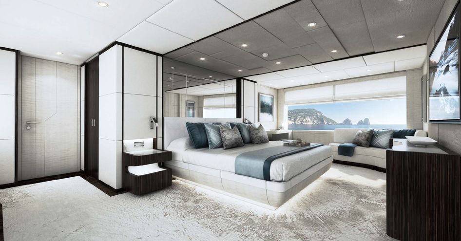 Majesty 120 master cabin, central berth with wide window in background and side tables.