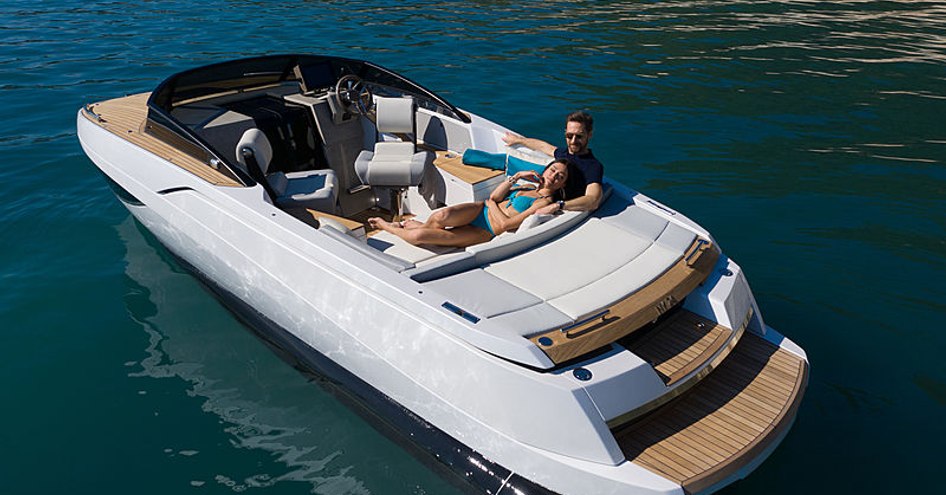 Rear view of Nerea Yachts NY24 stationary at sea with two people relaxing on aft seating