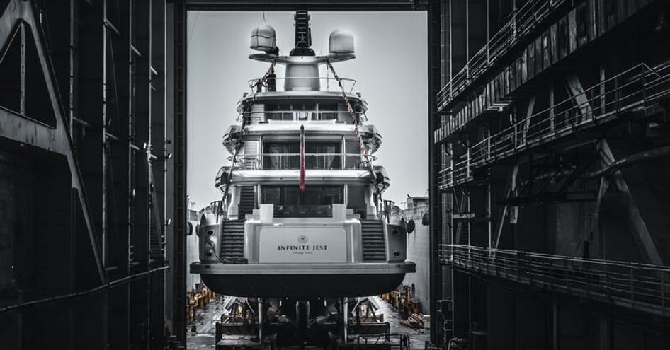 Aft view of superyacht Infinite Jest inside building shed.