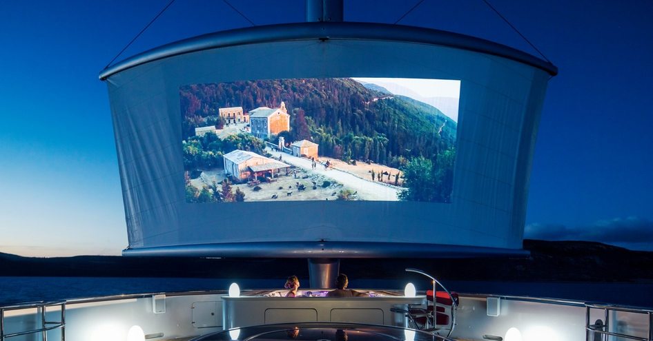 guests in jacuzzi watching movie on massive ondeck screen