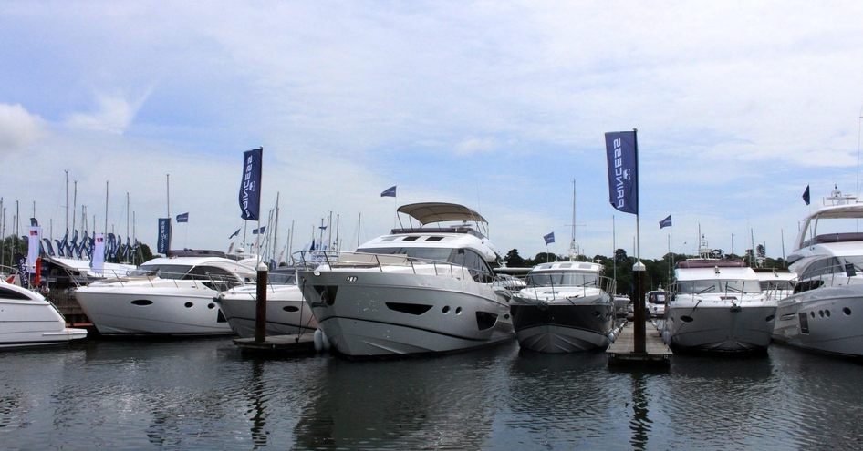 Princess Yachts display at British Motor Yacht Show. Line of berthed motor yachts.