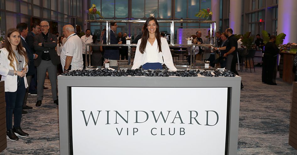 Windward VIP Experience at Miami International Boat Show. Female hostess posing behind reception desk.