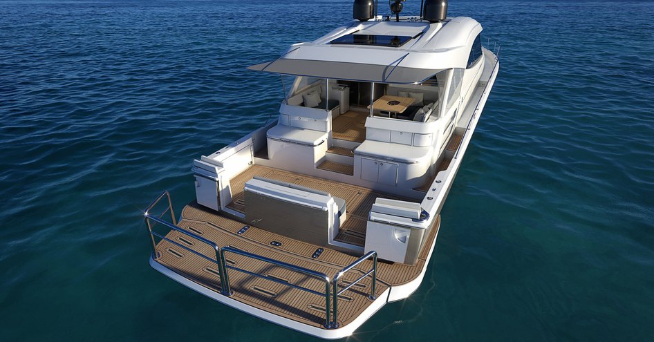 Aft view of Riviera 645 SUV, swim platform raised, with alfresco dining in background. Surrounded by sea.