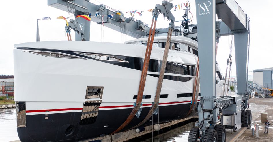 Side view of ISA M/Y UV II in a crane during launch ceremony.