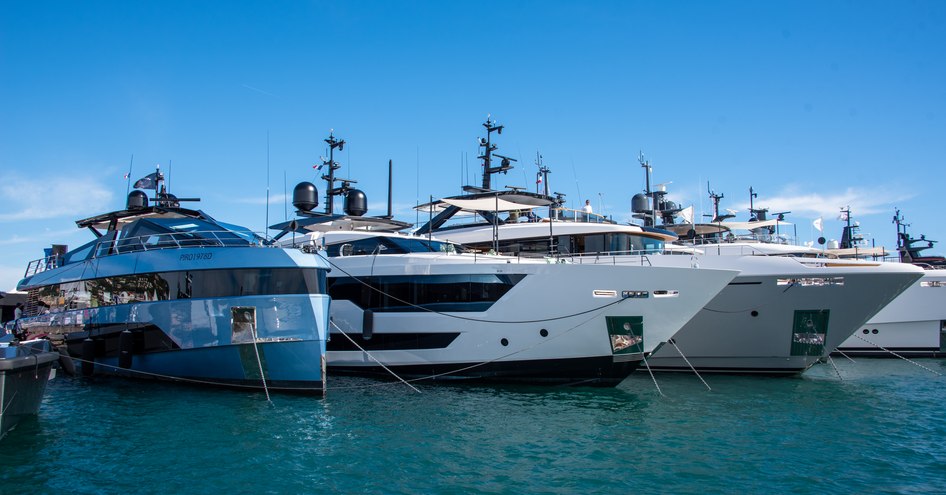 Superyachts berthed in a line at the Cannes Yachting Festival