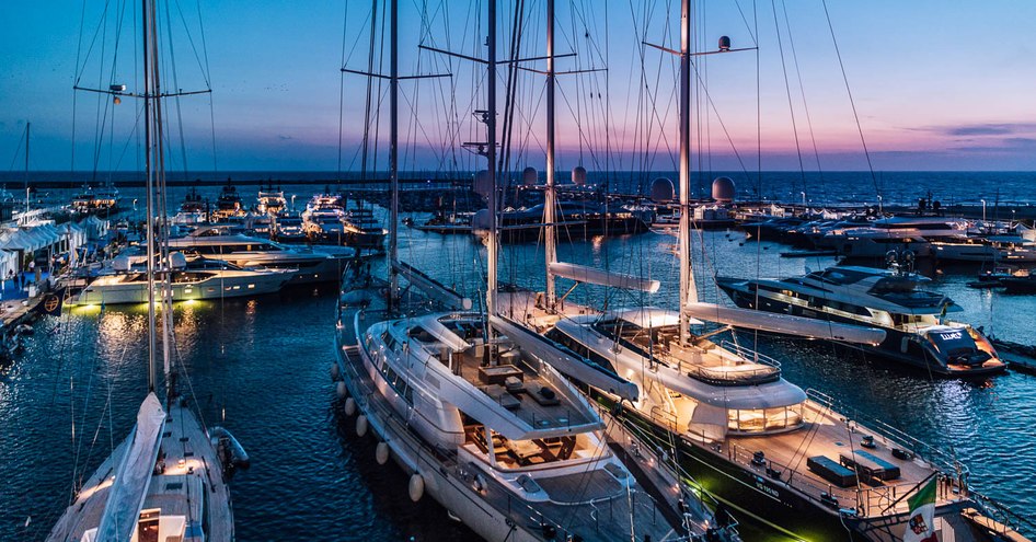 Sailing yachts moored at Versilia Yachting Rendezvous at dusk.