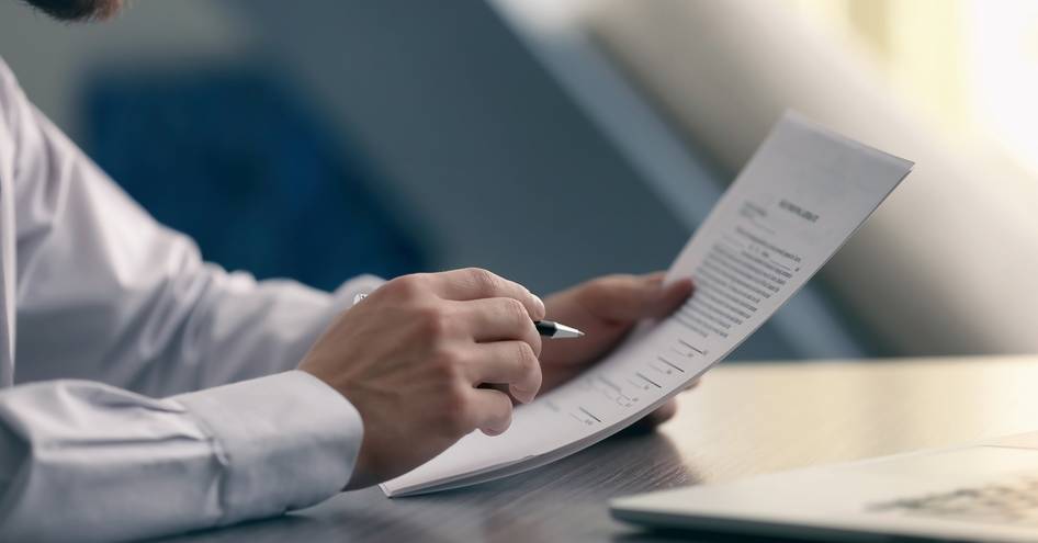 a man reading his contract agreement 