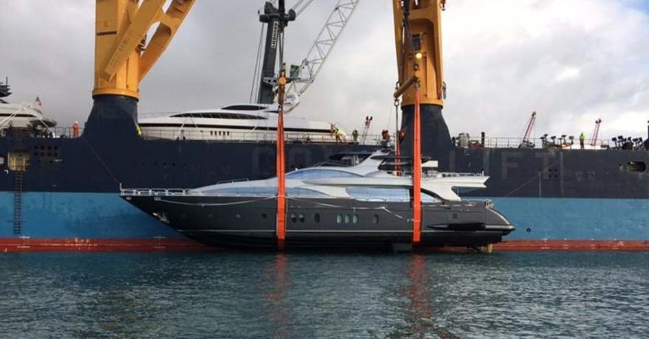 Yacht being unloaded from a transport boat