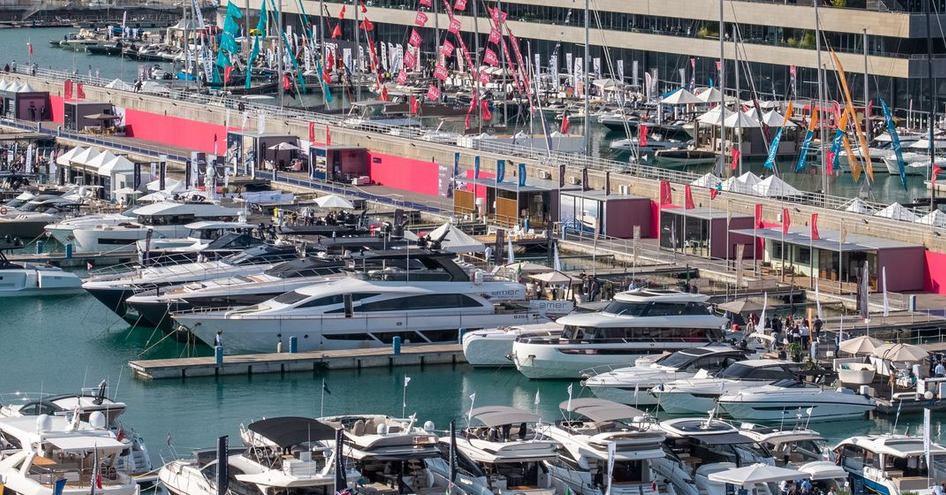 Elevated view looking down on the pontoons of the Genoa International Boat Show with many motor yachts for sale berthed