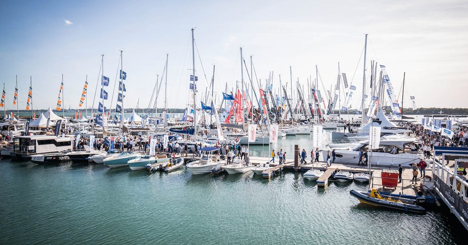 Line of berths at SIBS, multiple sailing boats anchored, surrounded by sea 