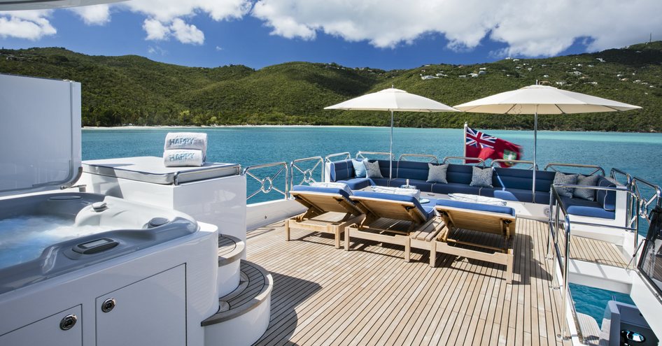 The exterior lounge of a Johnson 110 Skylounge yacht