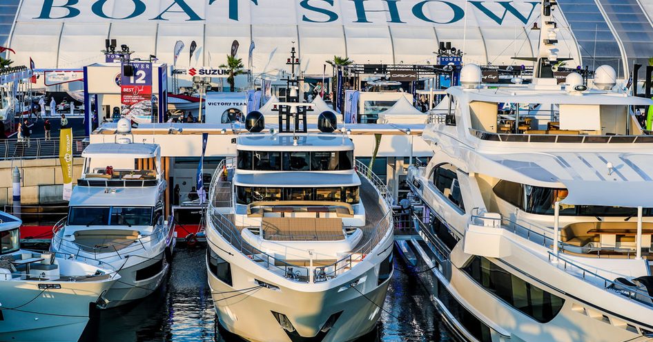 Superyachts berthed in front of exhibition tent at Dubai International Boat Show.