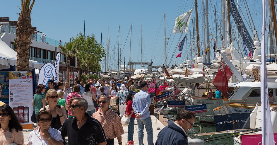 Ground view of Palma Superyacht Show exhibitors, lots of visitors walking along looking at displays.